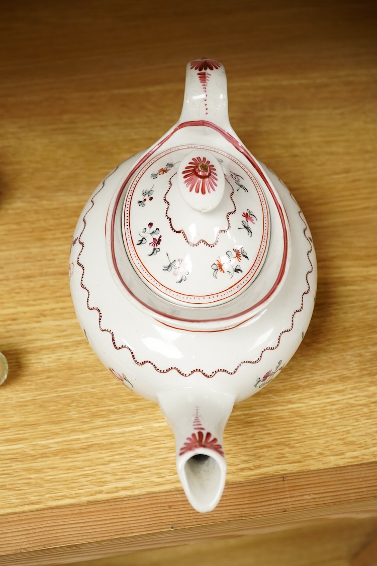 A Newhall porcelain boat shaped teapot, c.1800, together with a cream jug, tallest 14cm